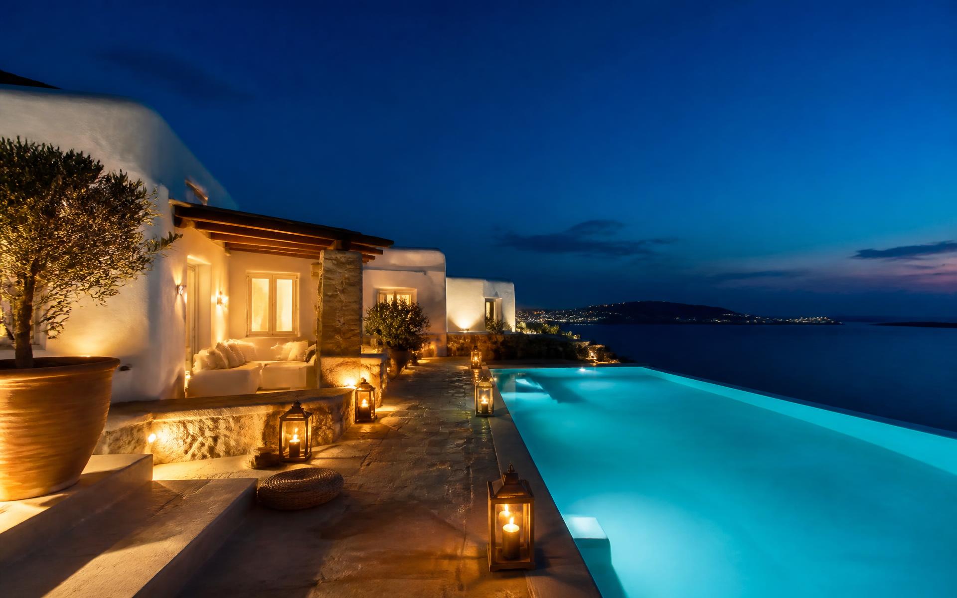 Aelia House terrace and lit pool at dusk